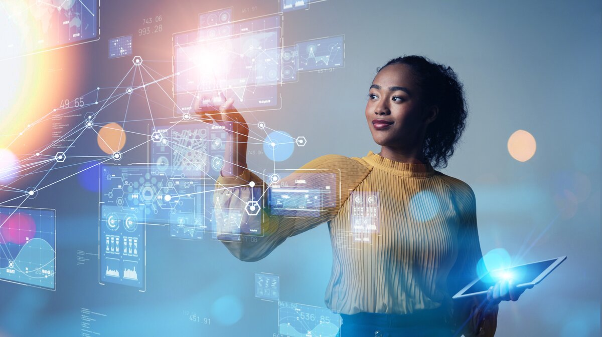 A woman interacting with projected data visualisations against a stylised blue background