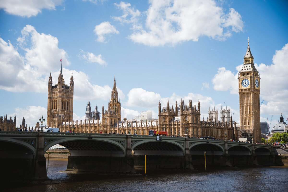 Big Ben and UK Parliament from across Westminster bridge in bright blue sky