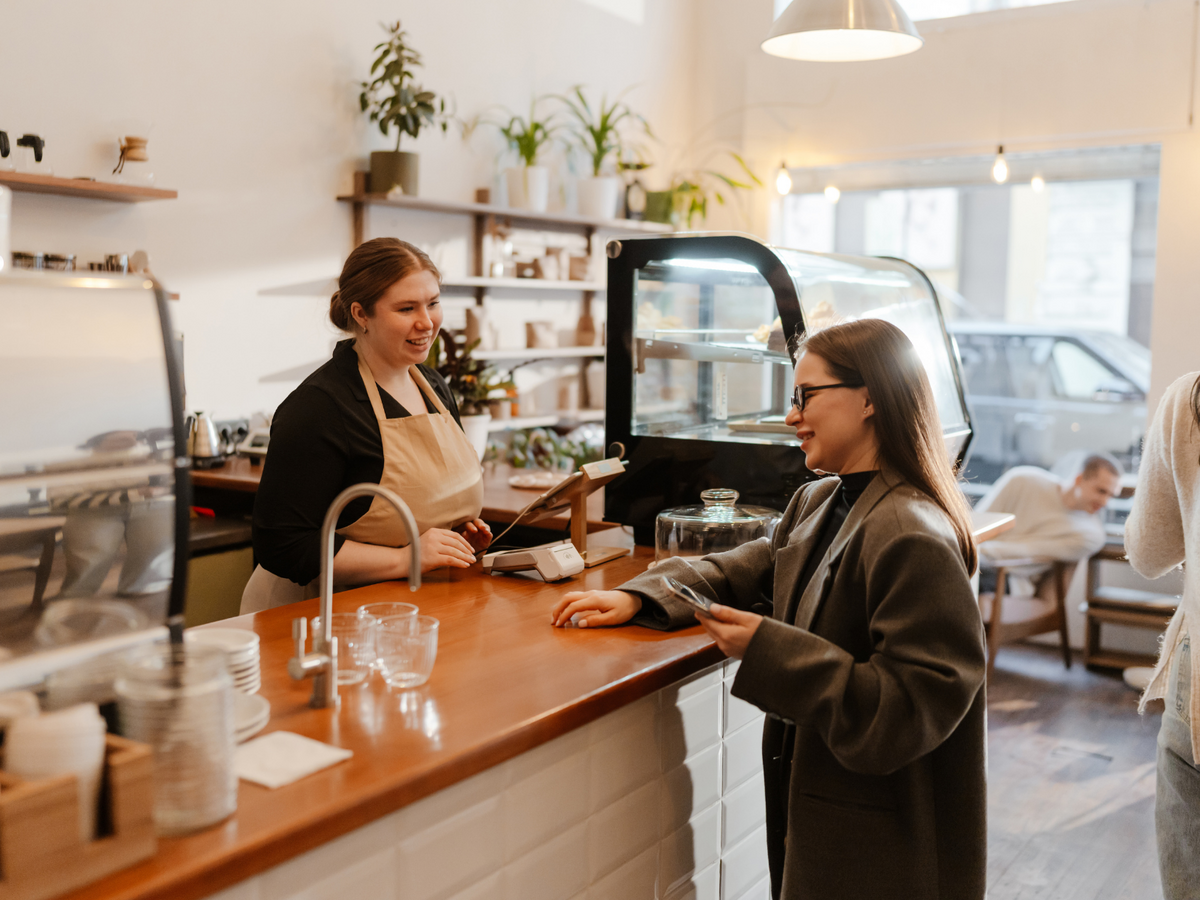 A barista serving a customer in a coffee shop