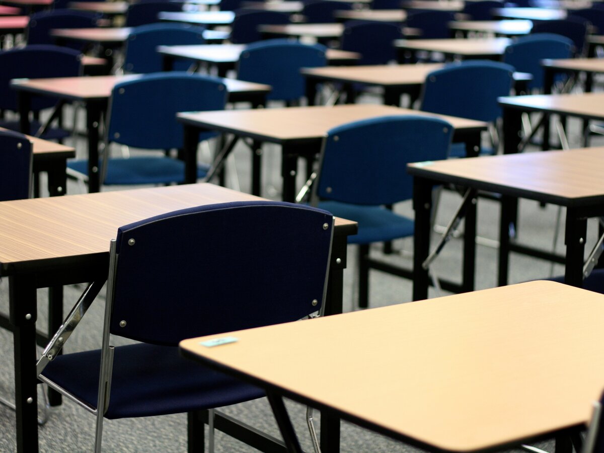 Rows of desks in an examination hall.