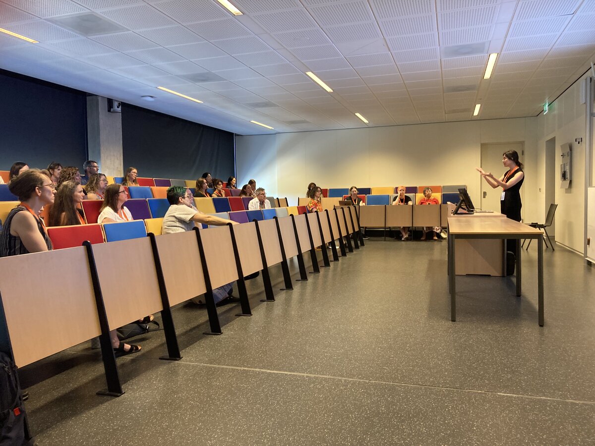 A researcher presents to a small lecture theatre full of people