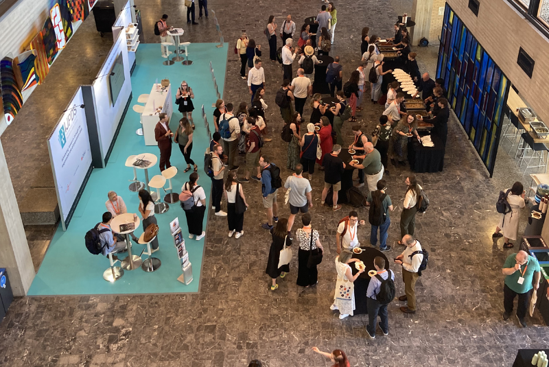 Image shows a birdseye view of delegates at a conference 